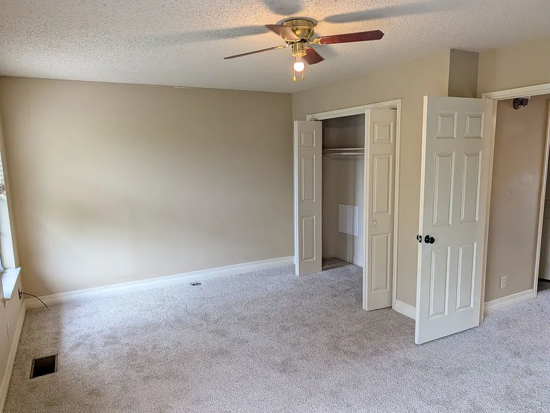 Bedroom with new carpet, closet, and door to the hall